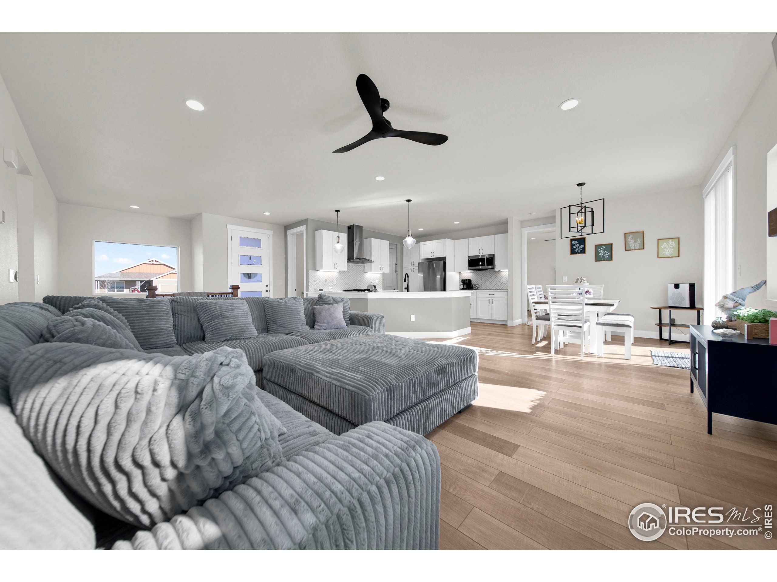 116 7th Avenue Wiggins, CO 80654 - Photo 9 of 42 a living room with furniture and a large window
