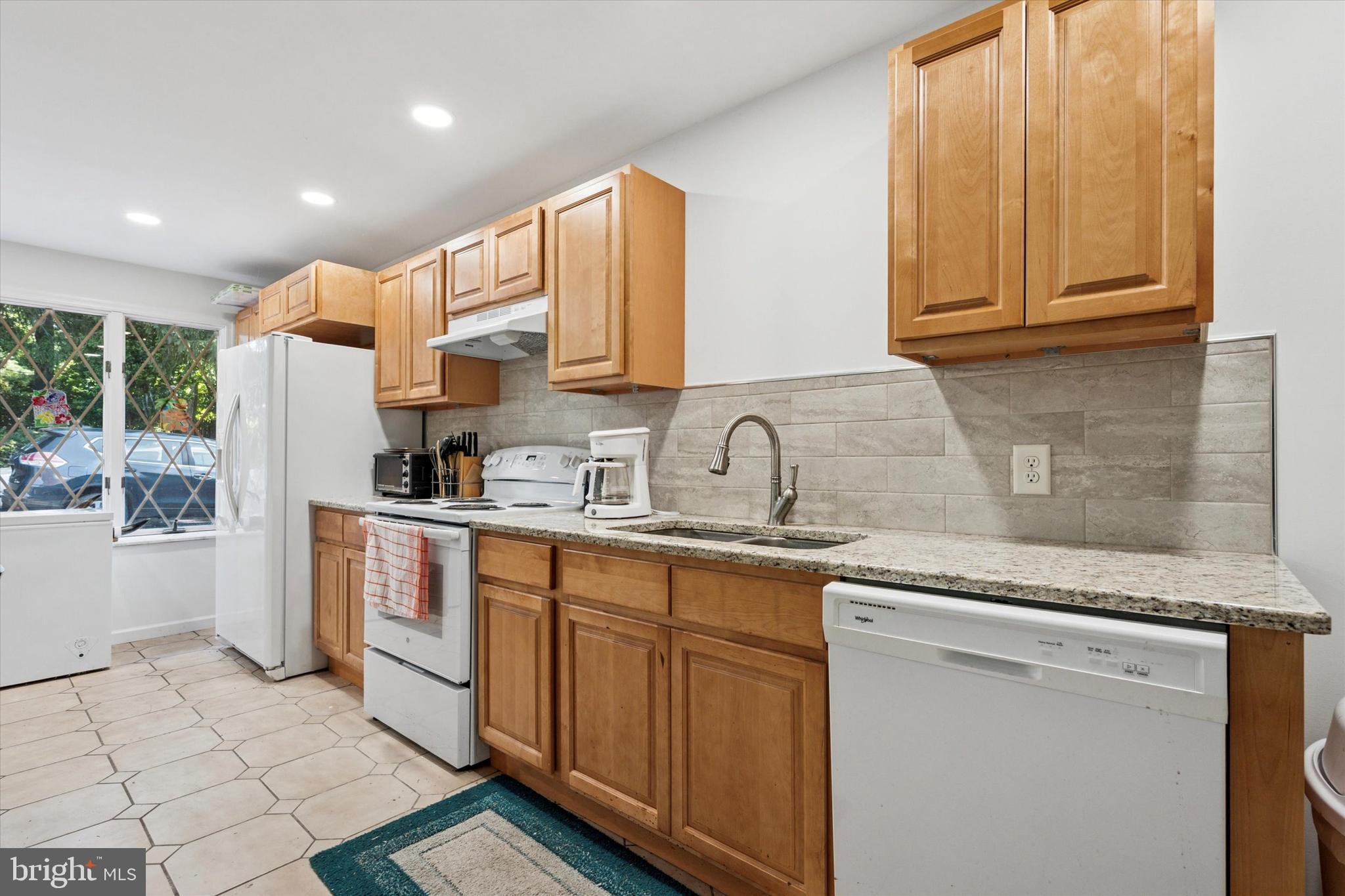 341 Cedar Road Elkins Park, PA 19027 - Photo 20 of 59 a kitchen with stainless steel appliances granite countertop a sink and a stove