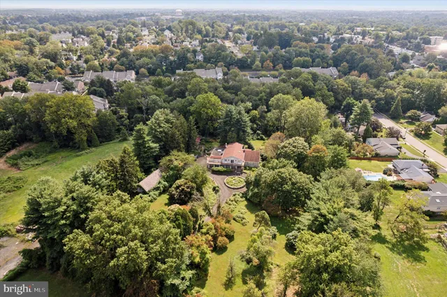 an aerial view of a garden with swimming pool