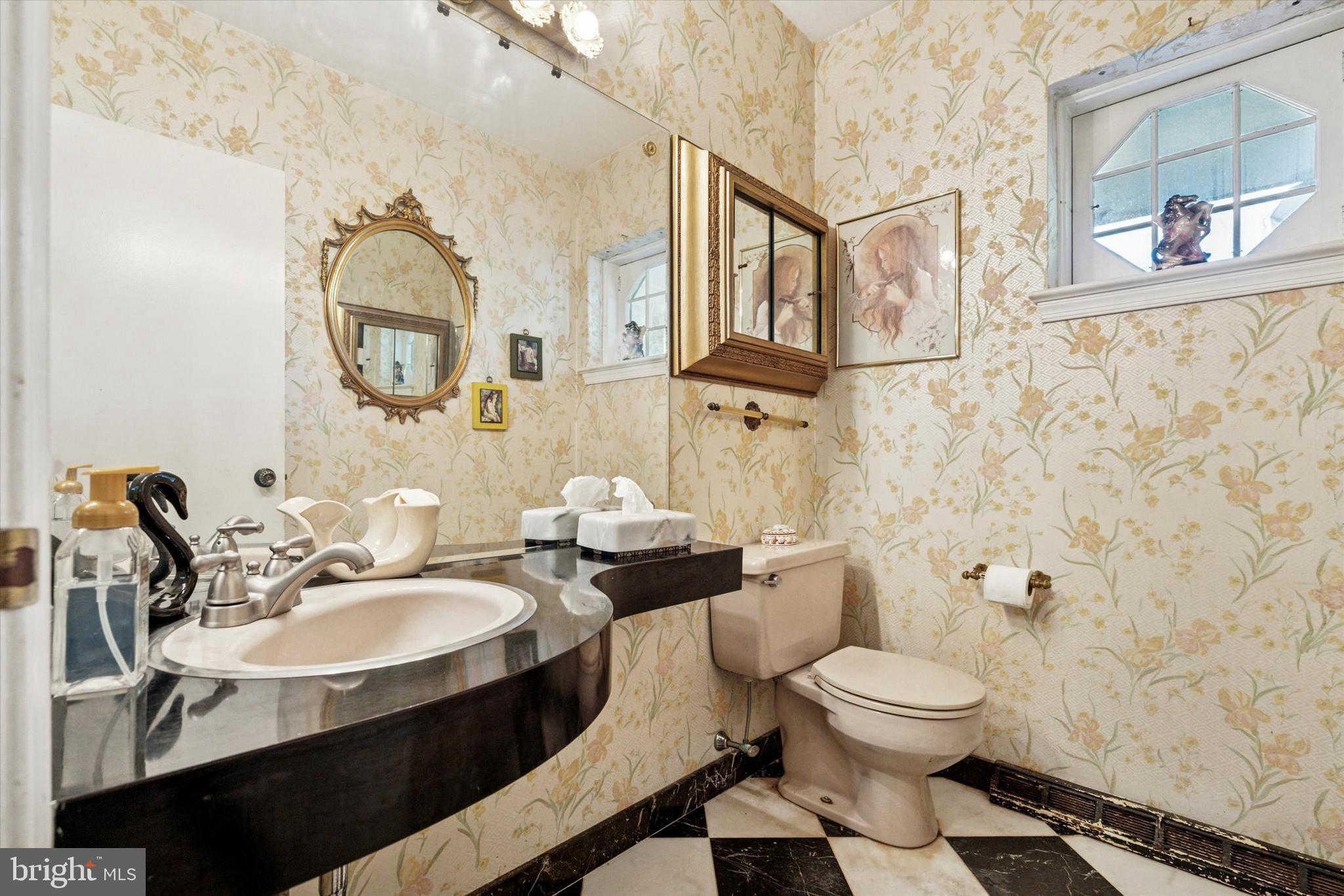 341 Cedar Road Elkins Park, PA 19027 - Photo 5 of 59 a bathroom with a toilet sink and mirror