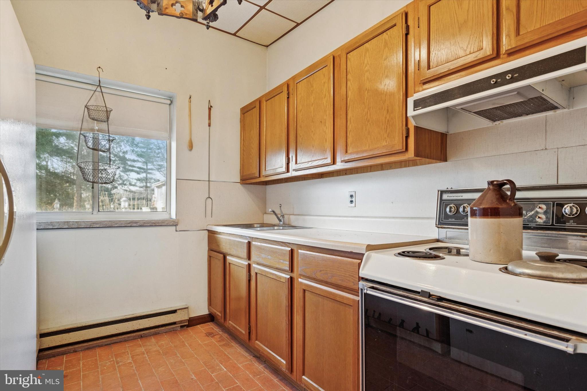341 Cedar Road Elkins Park, PA 19027 - Photo 53 of 59 a kitchen with stainless steel appliances granite countertop a sink a stove and a refrigerator