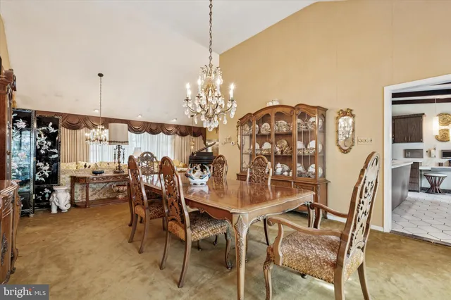 a view of a dining room with furniture and chandelier
