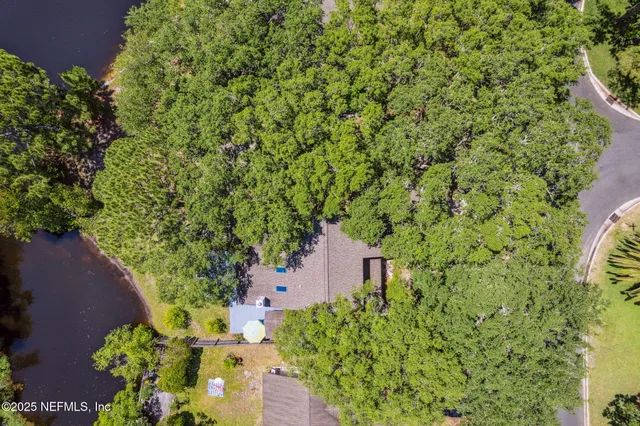 an aerial view of a house with a yard