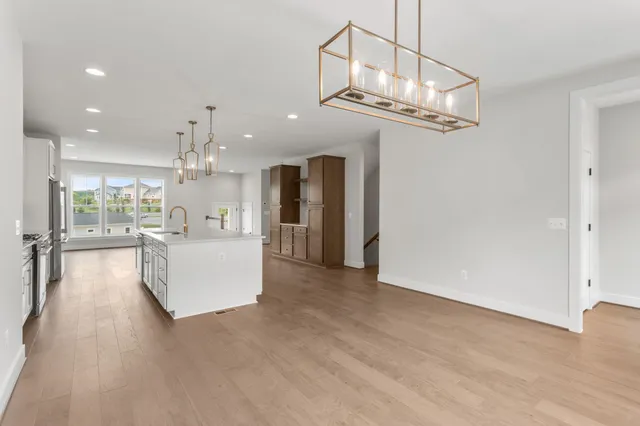 a large kitchen with stainless steel appliances granite countertop a refrigerator a oven a sink and a stove