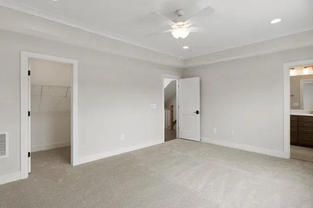 a view of a hallway with wooden floor and closet area
