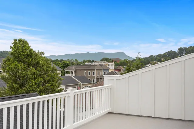 a view of a patio with couches table and chairs and potted plants