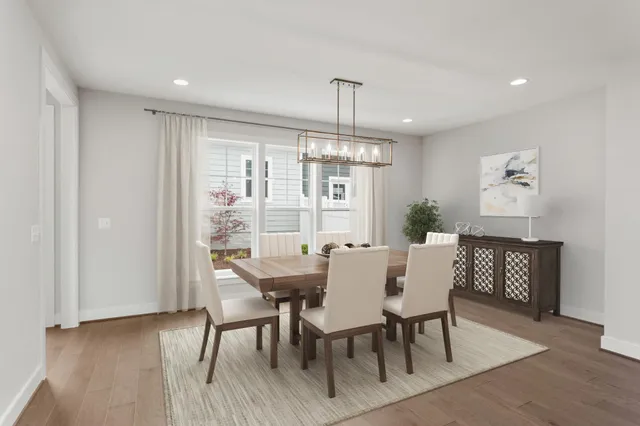 a view of a dining room with furniture window and wooden floor