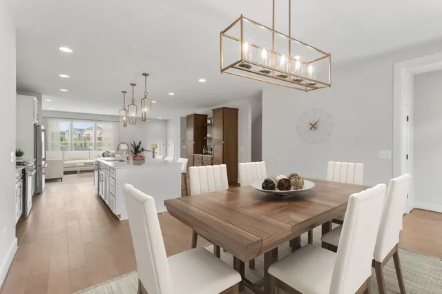 a view of a dining room with furniture and a chandelier