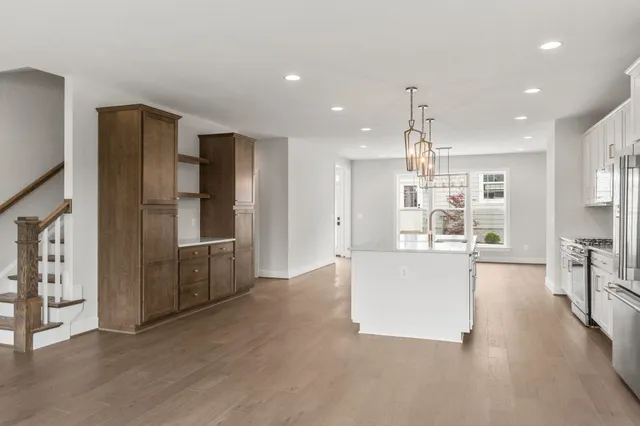 a living room with stainless steel appliances kitchen island granite countertop furniture and a kitchen view