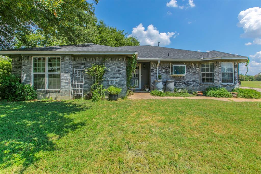 1936 Post Oak Drive Waco, TX 76705 - Photo 1 of 33 Ranch-style house with brick siding, a front lawn, and a shingled roof