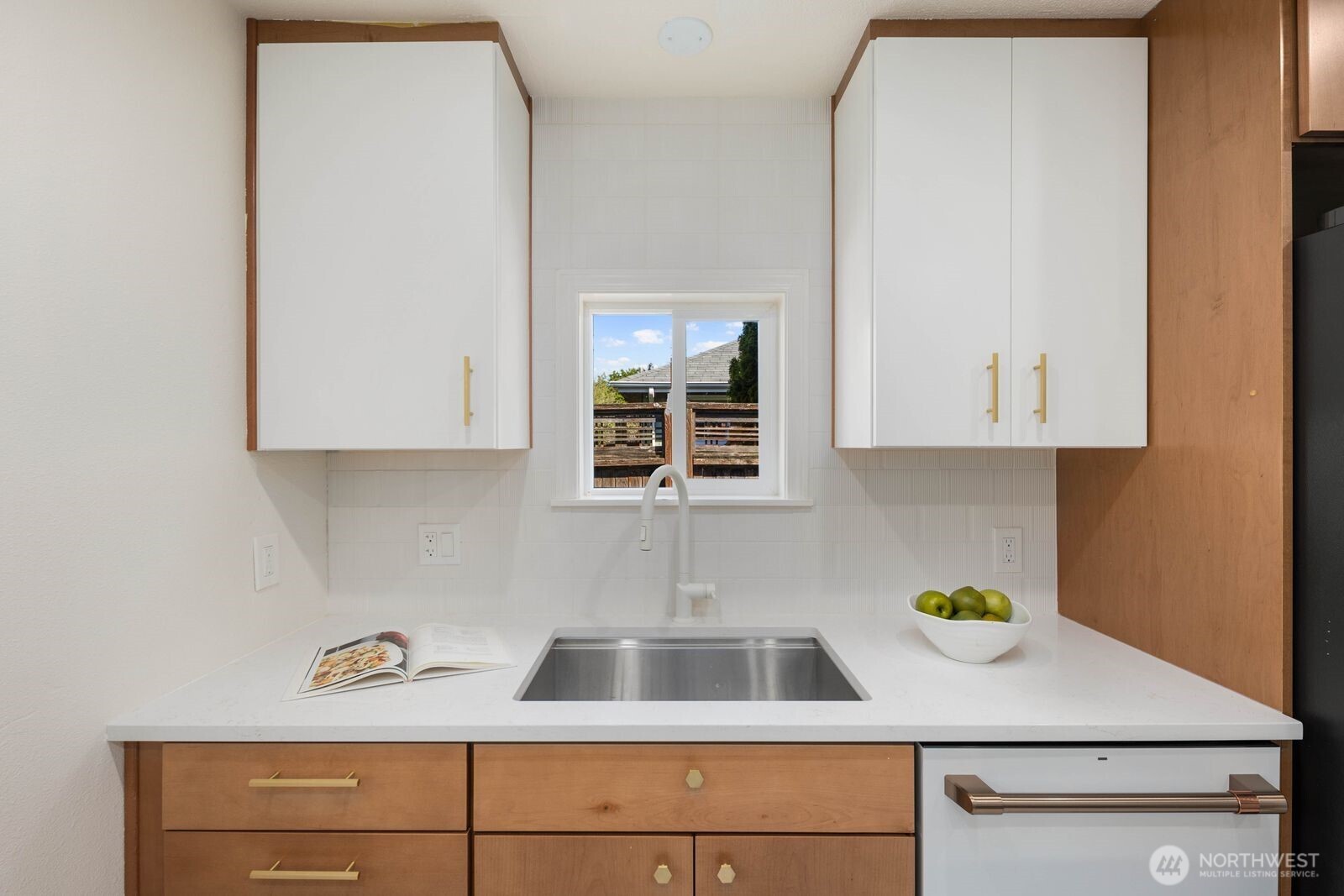 7508 30th Avenue Southwest Seattle, WA 98126 - Photo 11 of 39 a kitchen with a sink cabinets and window