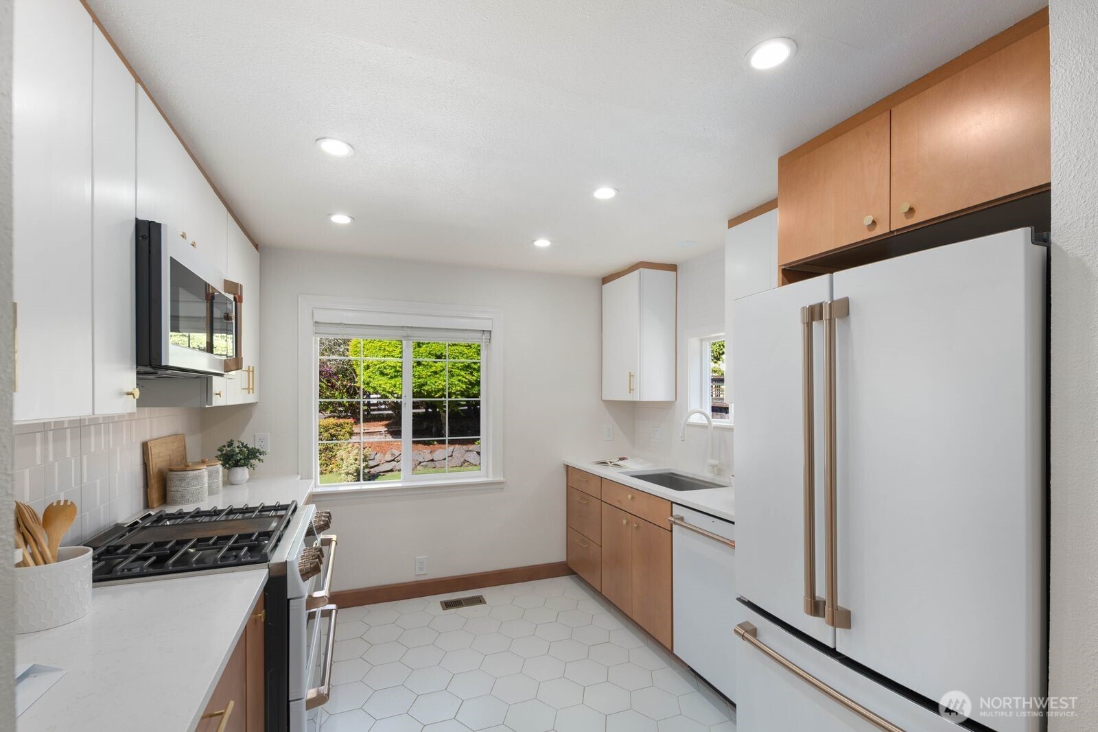 7508 30th Avenue Southwest Seattle, WA 98126 - Photo 12 of 39 a kitchen with stainless steel appliances granite countertop a refrigerator and a stove top oven