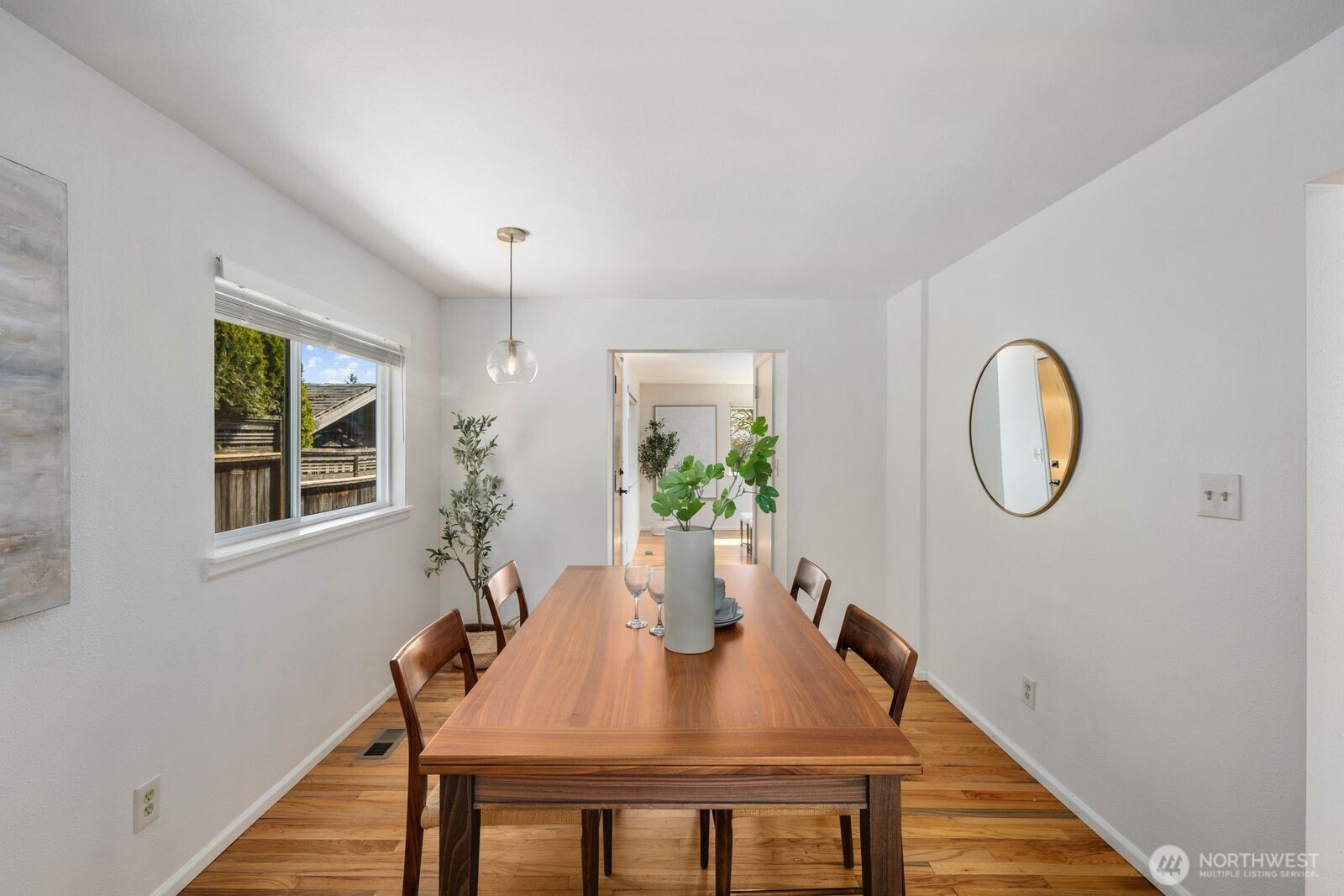 7508 30th Avenue Southwest Seattle, WA 98126 - Photo 13 of 39 a view of a dining room with furniture window and wooden floor