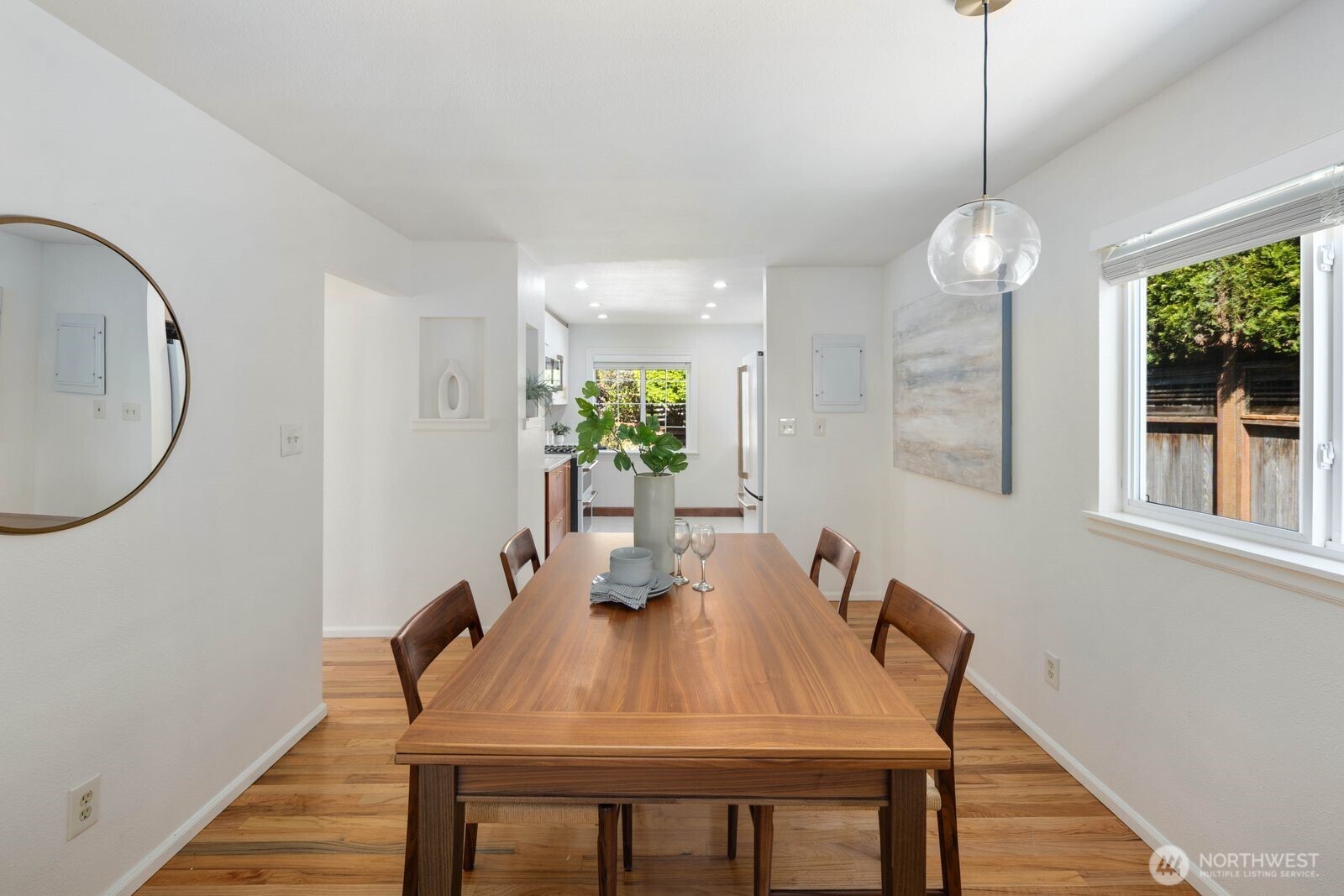 7508 30th Avenue Southwest Seattle, WA 98126 - Photo 14 of 39 a view of a dining room with furniture window and wooden floor