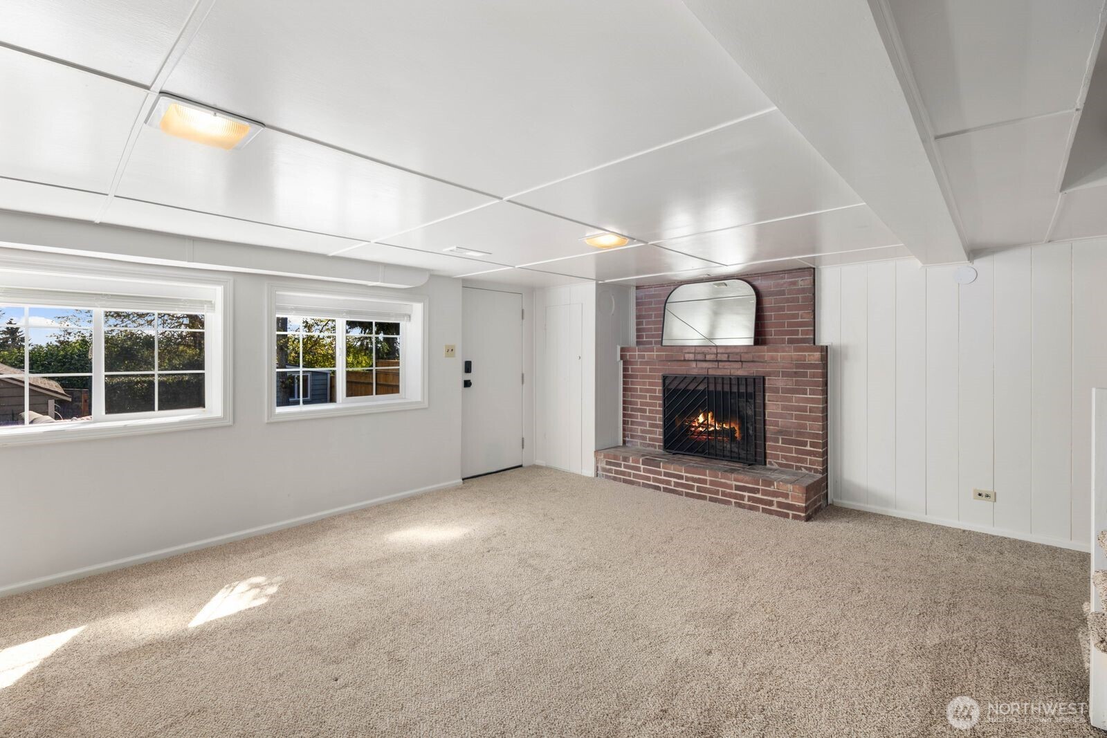 7508 30th Avenue Southwest Seattle, WA 98126 - Photo 22 of 39 a view of an empty room with a fireplace and a window