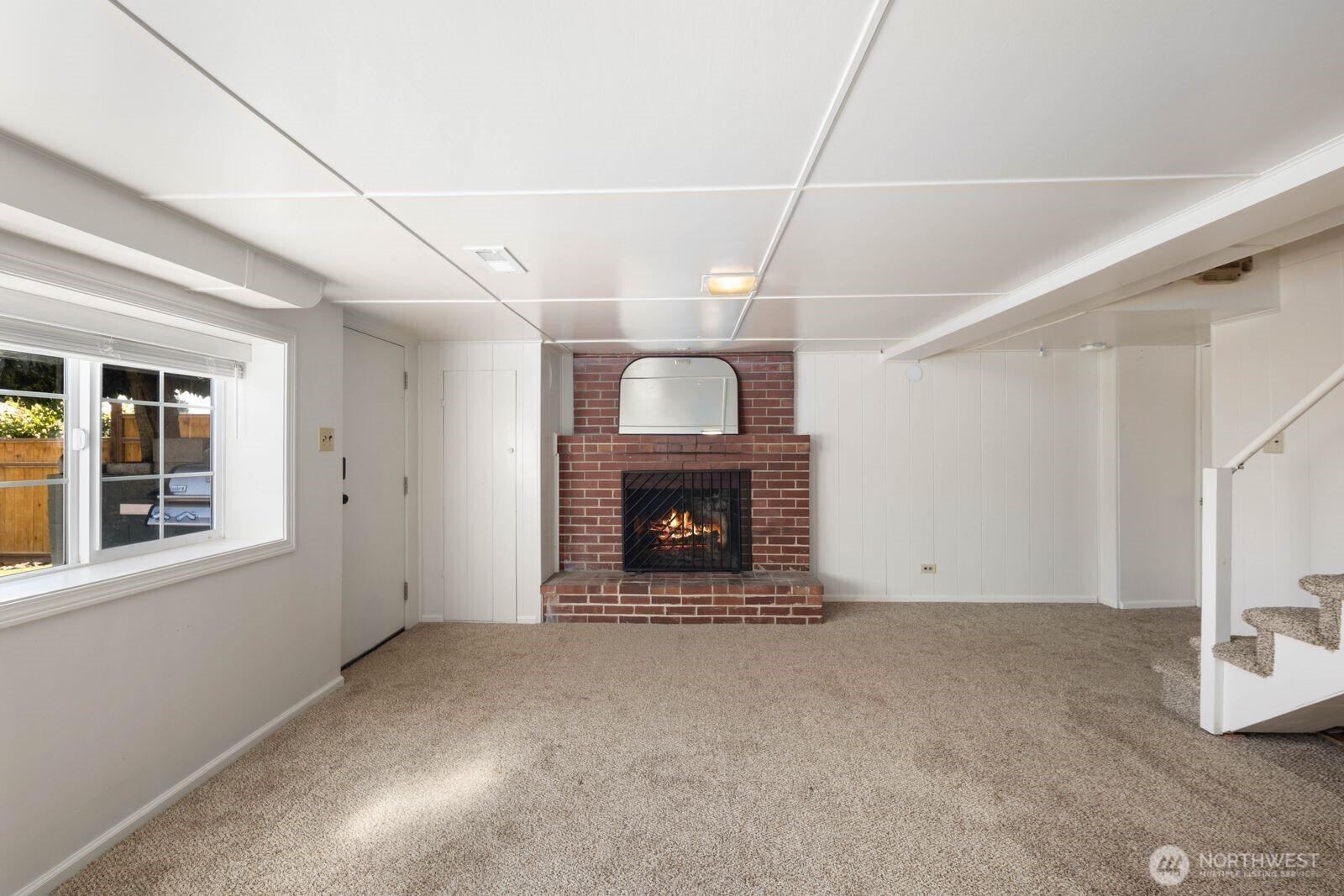 7508 30th Avenue Southwest Seattle, WA 98126 - Photo 23 of 39 an empty room with windows and fireplace