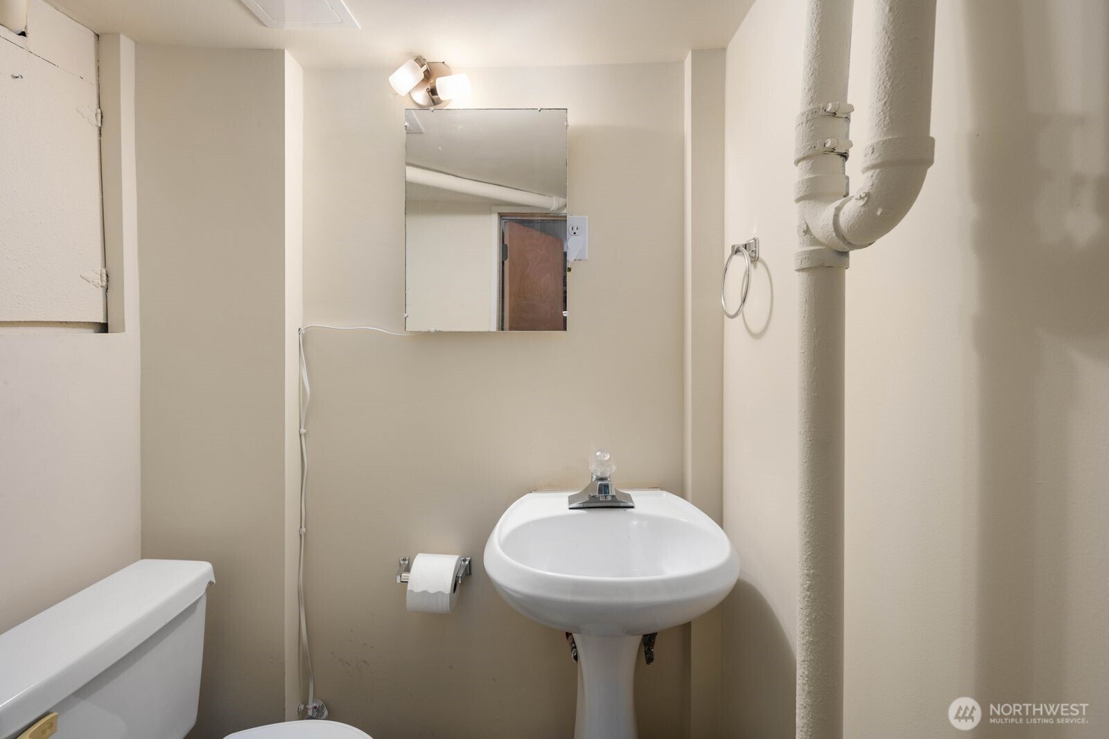 7508 30th Avenue Southwest Seattle, WA 98126 - Photo 25 of 39 a bathroom with a sink a toilet and mirror
