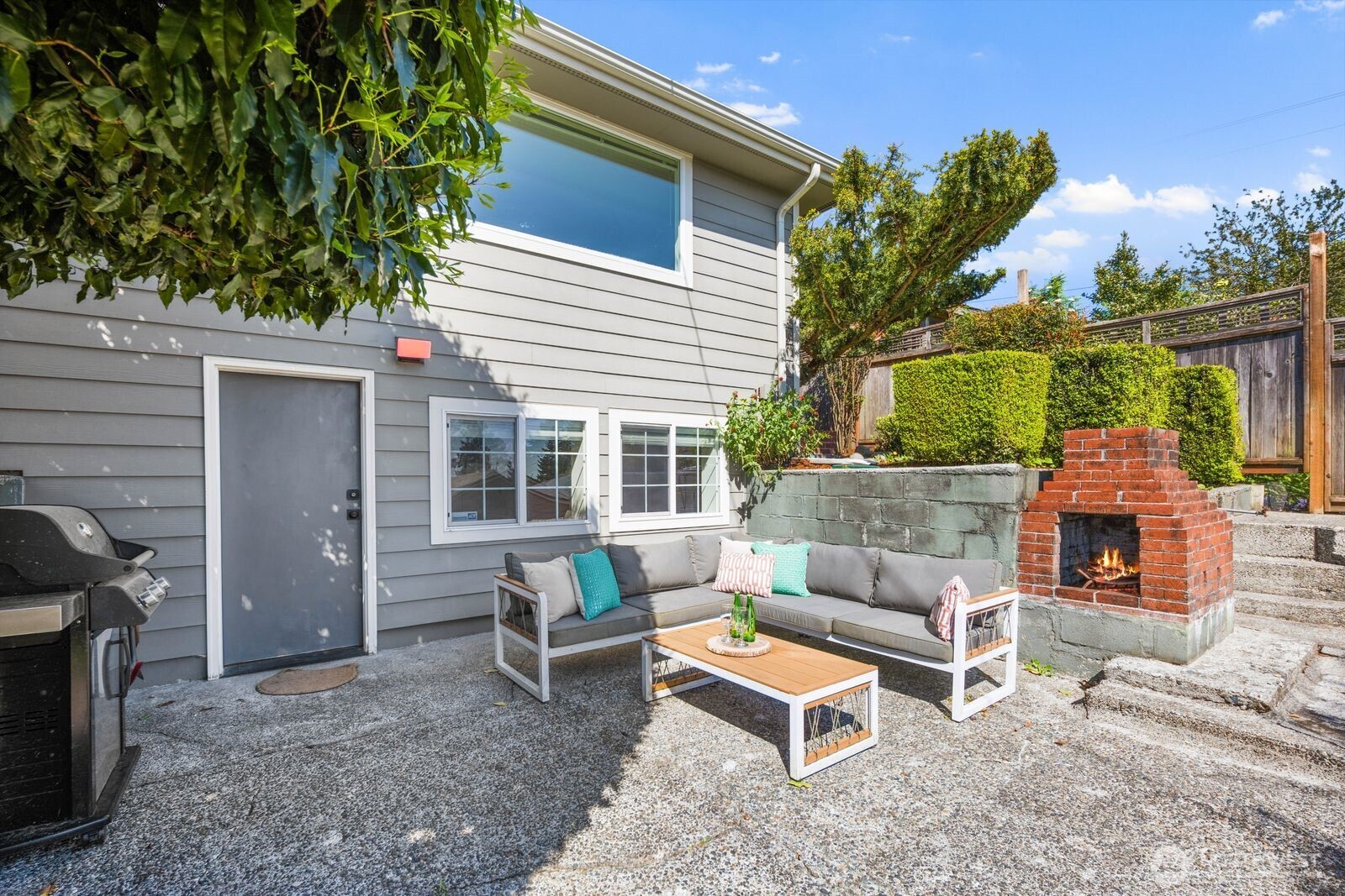 7508 30th Avenue Southwest Seattle, WA 98126 - Photo 31 of 39 a balcony with furniture and a potted plant