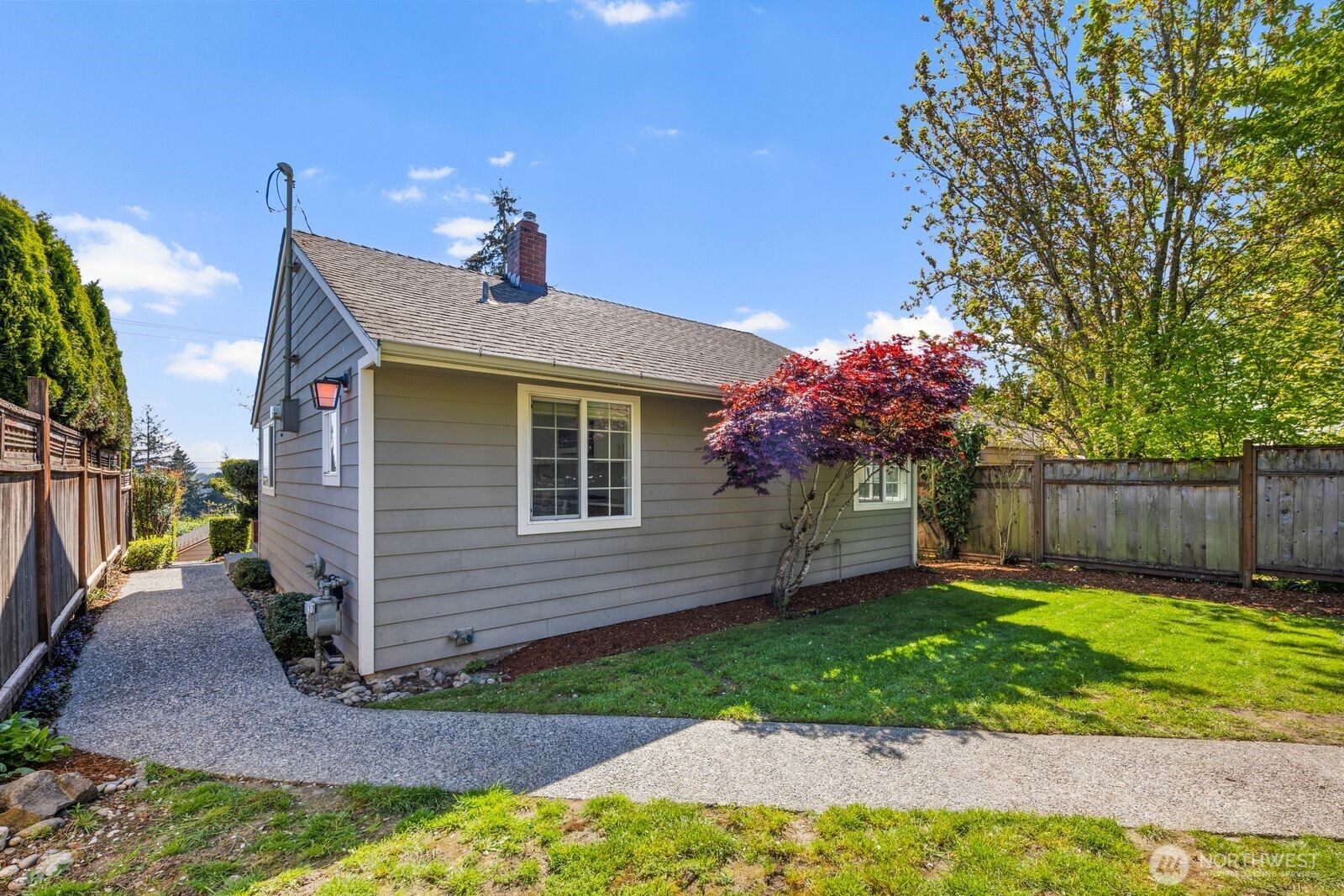 7508 30th Avenue Southwest Seattle, WA 98126 - Photo 32 of 39 a front view of a house with a yard and a garden
