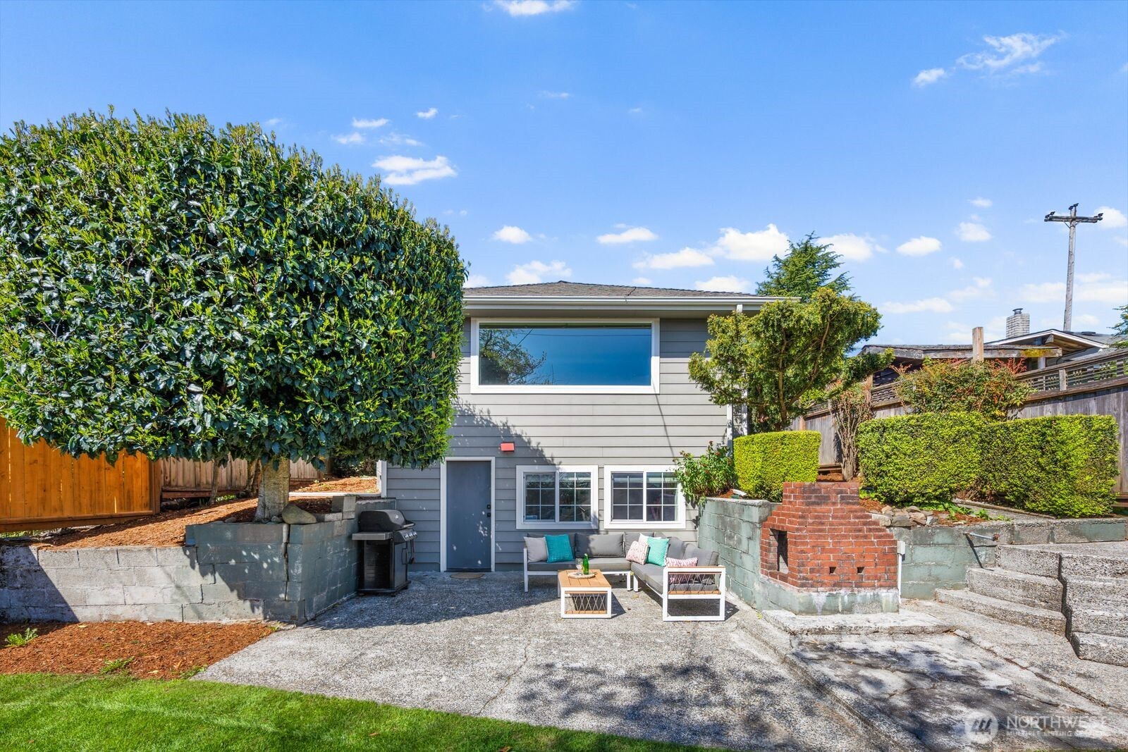 7508 30th Avenue Southwest Seattle, WA 98126 - Photo 33 of 39 a view of a patio with table and chairs and potted plants