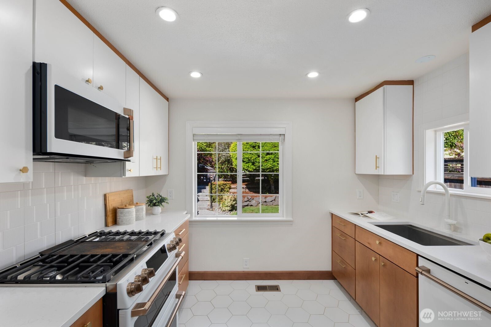 7508 30th Avenue Southwest Seattle, WA 98126 - Photo 8 of 39 a kitchen that has a sink and a stove top oven