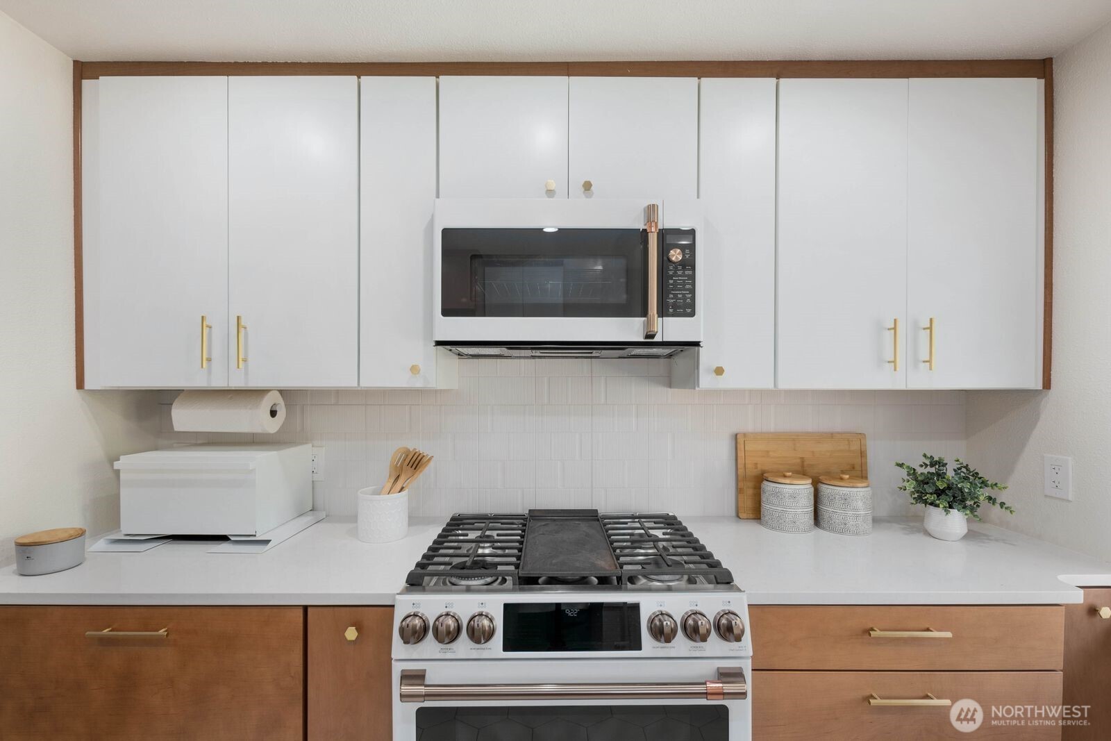 7508 30th Avenue Southwest Seattle, WA 98126 - Photo 10 of 39 a kitchen with stainless steel appliances white cabinets and a stove top oven