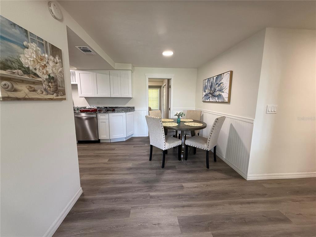 3625 Windham Drive Holiday, FL 34691 - Photo 13 of 28 a view of a dining room with furniture and wooden floor