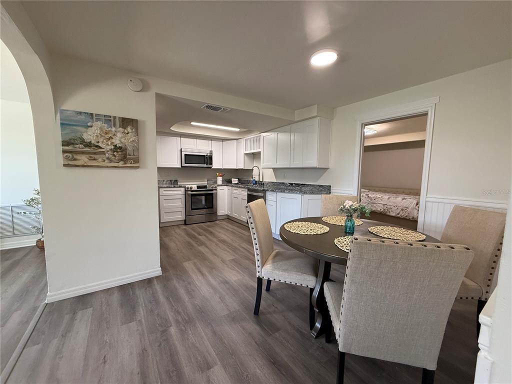 3625 Windham Drive Holiday, FL 34691 - Photo 14 of 28 a view of a dining room with furniture and wooden floor