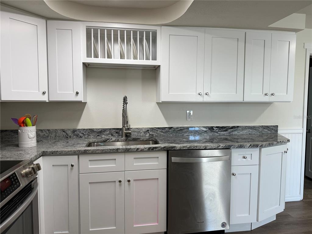 3625 Windham Drive Holiday, FL 34691 - Photo 2 of 28 a kitchen with granite countertop white cabinets and a stove