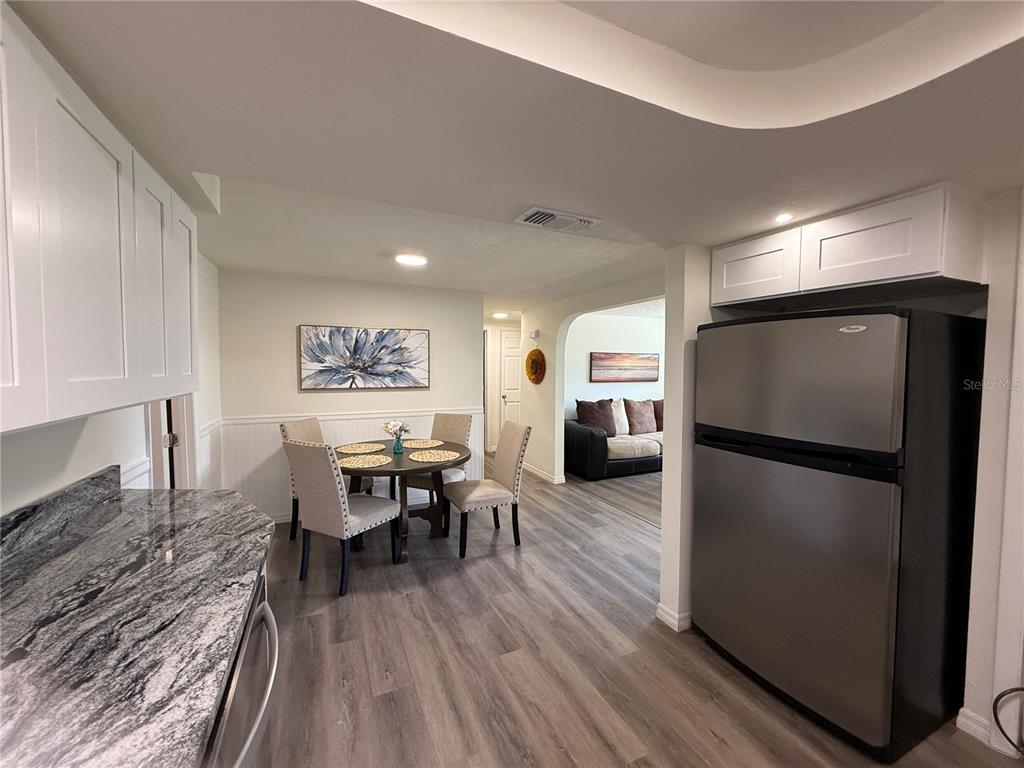 3625 Windham Drive Holiday, FL 34691 - Photo 8 of 28 a living room with furniture a table and kitchen view