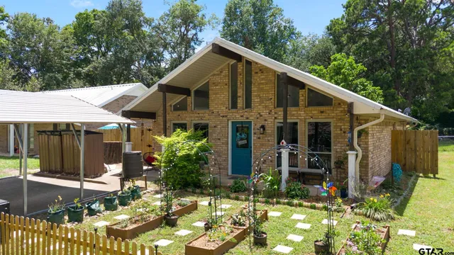 a view of a house with yard and sitting area