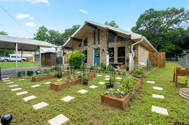 a front view of a house with garden
