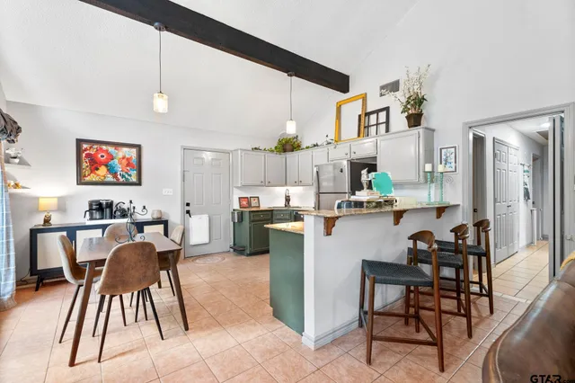 a dining room with furniture and a kitchen view