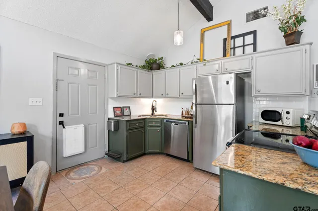 a kitchen with a refrigerator and a sink