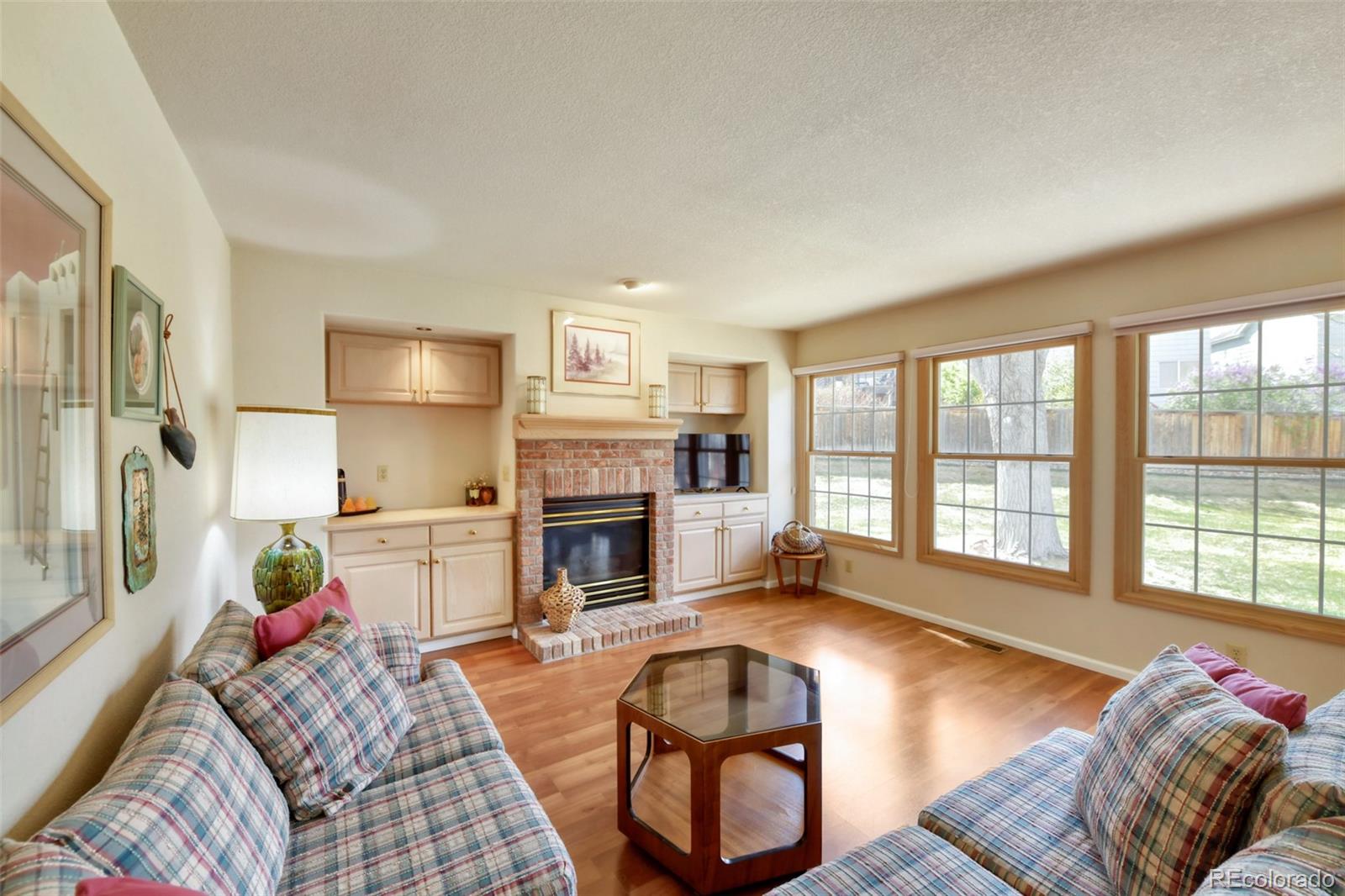 4823 Greenwich Place Highlands Ranch, CO 80130 - Photo 11 of 28 a living room with furniture and a fireplace