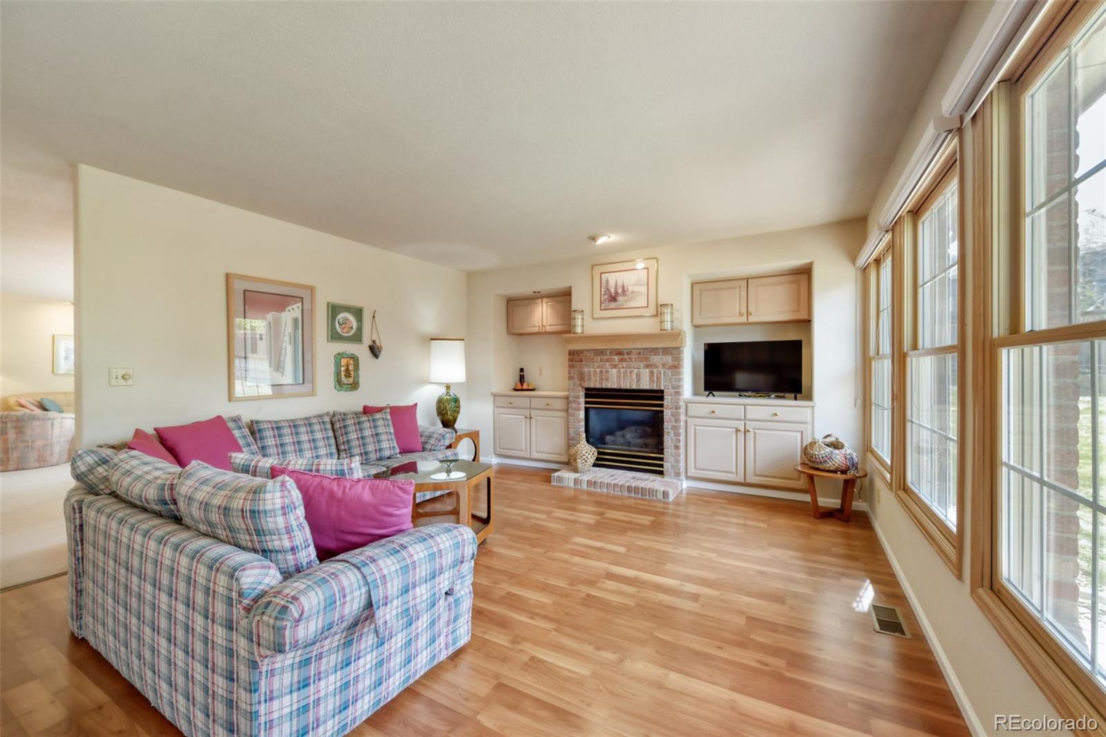4823 Greenwich Place Highlands Ranch, CO 80130 - Photo 12 of 28 a living room with furniture and a fireplace