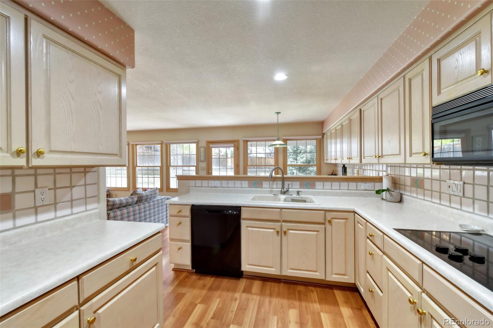 4823 Greenwich Place Highlands Ranch, CO 80130 - Photo 13 of 28 a kitchen with a sink stove and cabinets