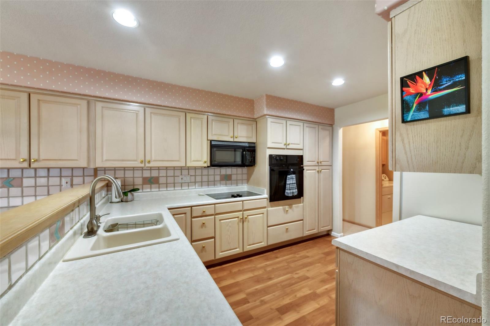 4823 Greenwich Place Highlands Ranch, CO 80130 - Photo 16 of 28 a large kitchen with stainless steel appliances kitchen island a large counter top a stove and a refrigerator