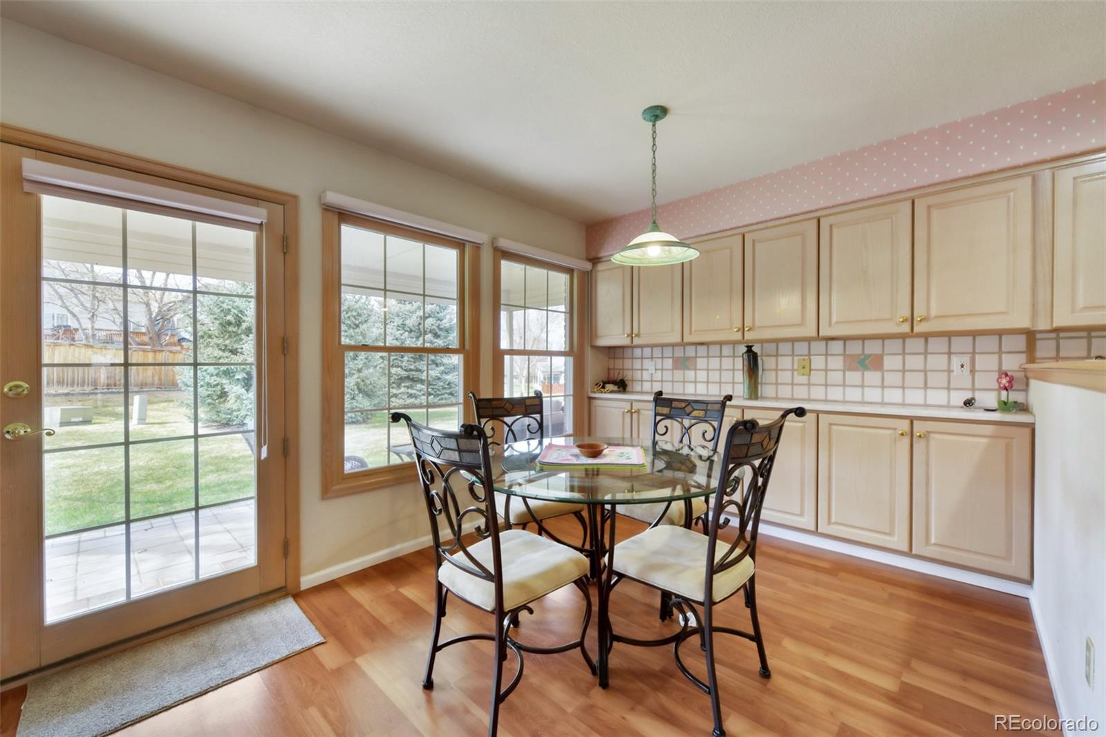 4823 Greenwich Place Highlands Ranch, CO 80130 - Photo 18 of 28 a view of a dining room with furniture window and wooden floor