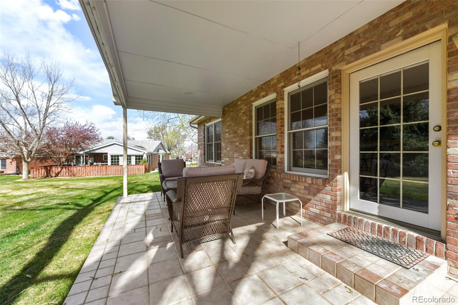 4823 Greenwich Place Highlands Ranch, CO 80130 - Photo 24 of 28 a view of a house with backyard sitting area and garden