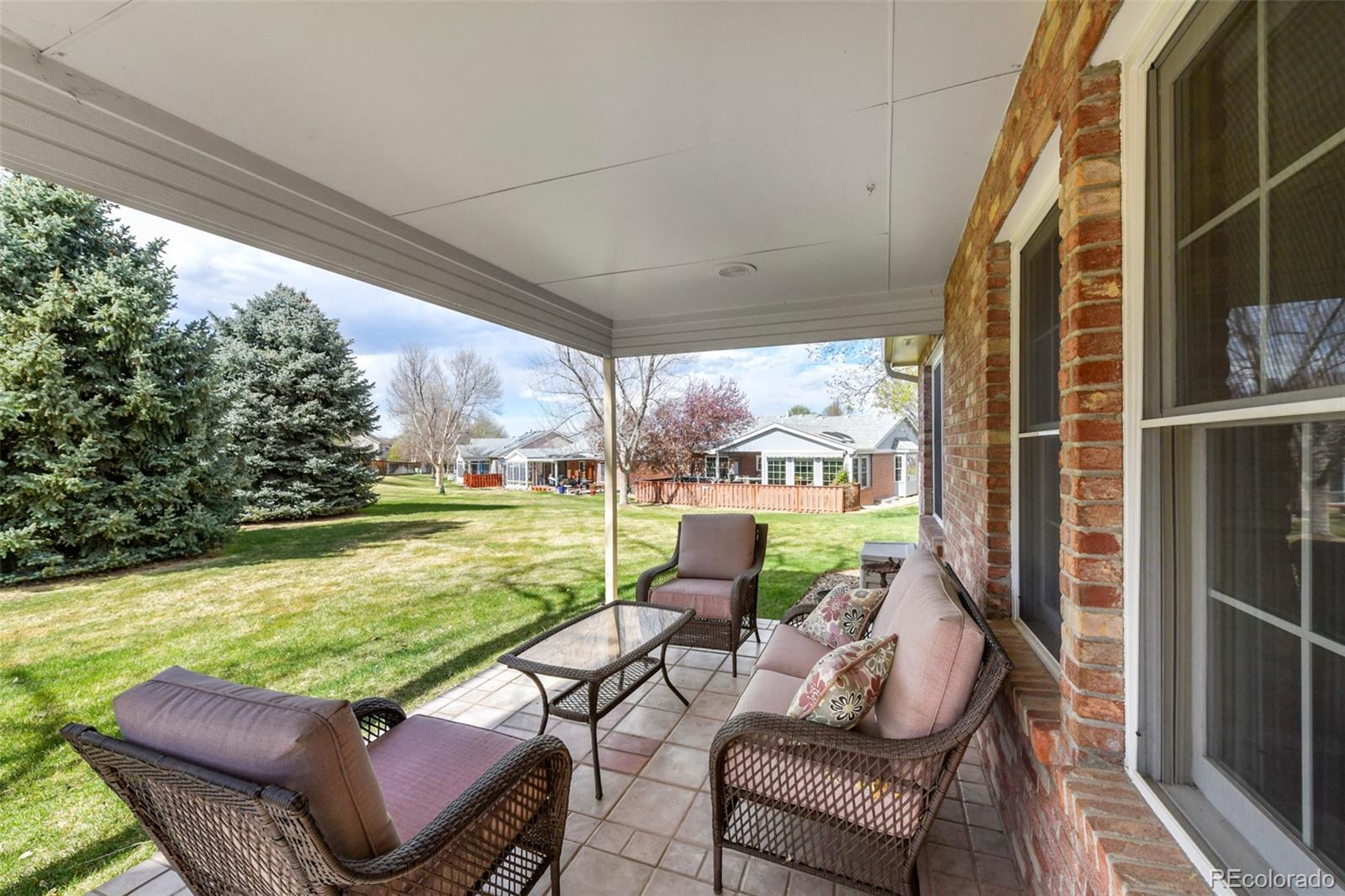 4823 Greenwich Place Highlands Ranch, CO 80130 - Photo 25 of 28 a view of a chairs and table in patio with a lake view