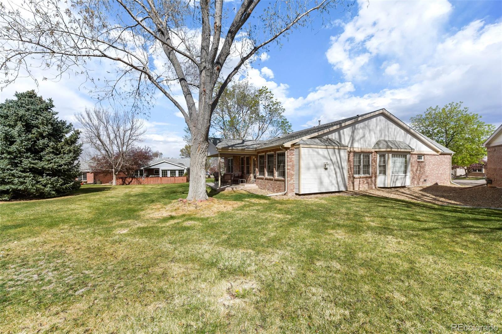 4823 Greenwich Place Highlands Ranch, CO 80130 - Photo 27 of 28 a view of a house with a big yard and large trees