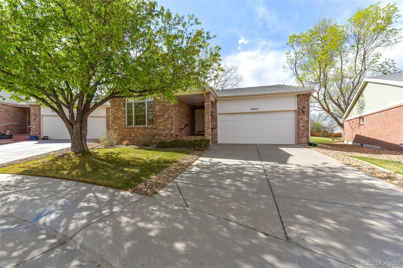 4823 Greenwich Place Highlands Ranch, CO 80130 - Photo 3 of 28 a view of a house with a yard and large tree