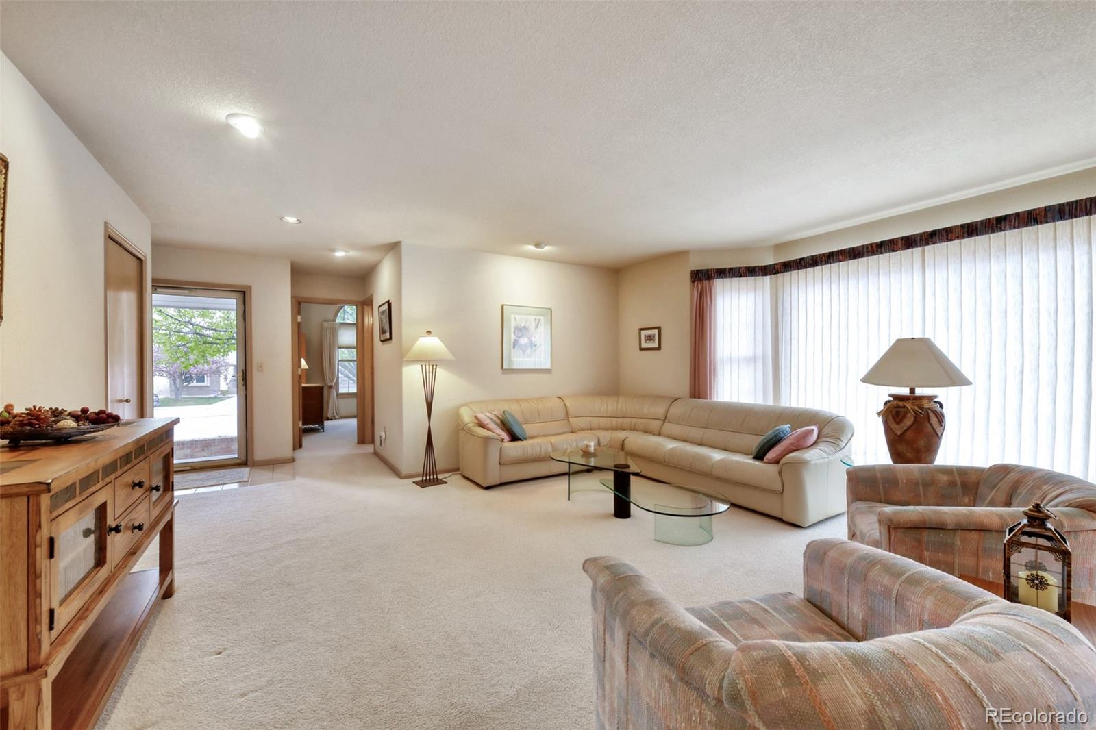 4823 Greenwich Place Highlands Ranch, CO 80130 - Photo 9 of 28 a living room with furniture and a large window
