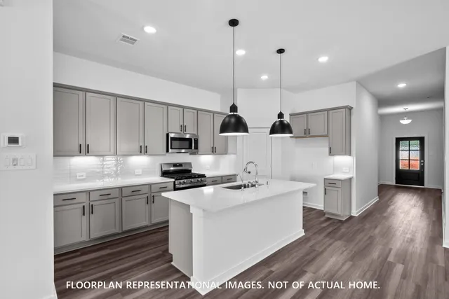 a kitchen with stove a sink and refrigerator