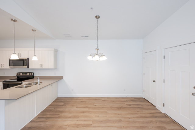 4664 South 680th West, Unit S304 Mapleton, UT 84664 - Photo 13 of 16 Open-concept kitchen and dining area featuring light wood-finish flooring