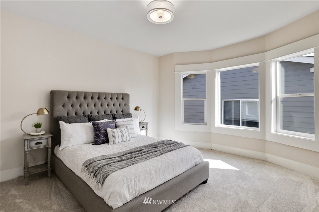 162 18th Avenue Seattle, WA 98122 - Photo 18 of 38 a bedroom with a bed and a large window