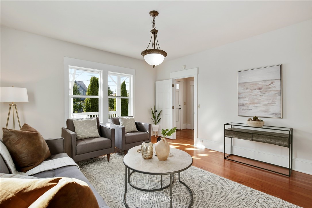 162 18th Avenue Seattle, WA 98122 - Photo 3 of 38 a living room with furniture a window and a chandelier
