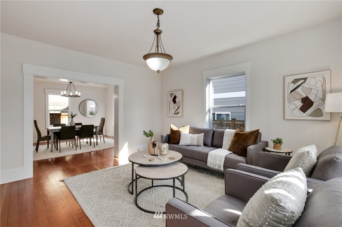 162 18th Avenue Seattle, WA 98122 - Photo 5 of 38 a living room with furniture a dining table and wooden floor