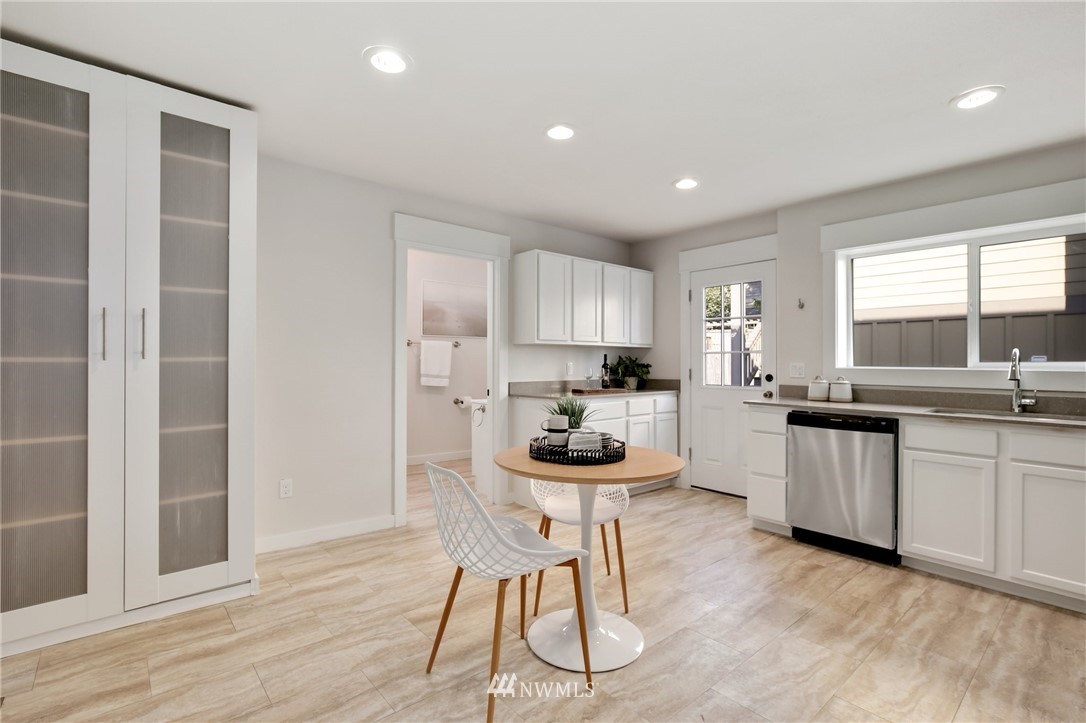 162 18th Avenue Seattle, WA 98122 - Photo 9 of 38 a kitchen with a sink and chairs